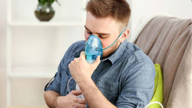 Man with asthma using ventilator