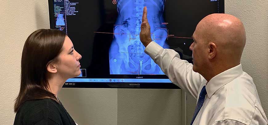 Chiropractor discussing x-ray results with patient