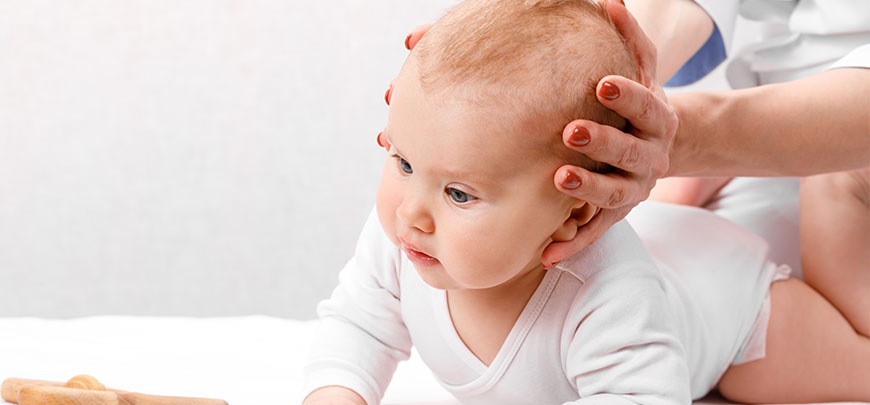 Infant receiving Chiropractic adjustment for colic relief